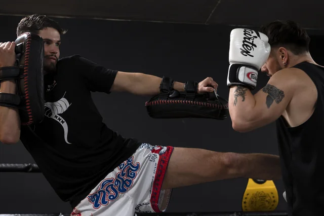 Kick drill on the pads during a Muay Thai session